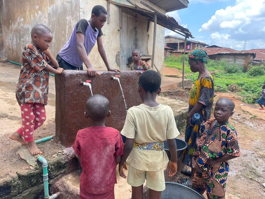Children gathered around a two-tap stand